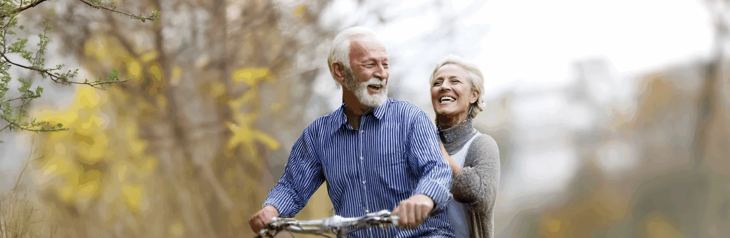 senior couple riding bike in the fall